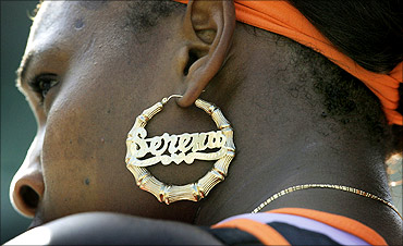 Serena Williams wearing a dazzling gold earring.