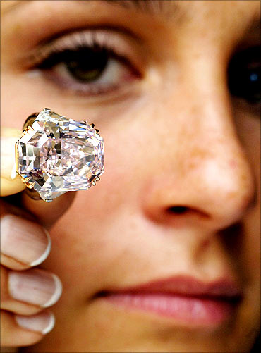 A rare intense purple-pink cut-cornered rectangular mixed-cut diamond ring
