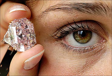 A rare intense purple-pink cut-cornered rectangular mixed-cut diamond ring.