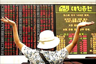 An investor looks at stock price index in Seoul.