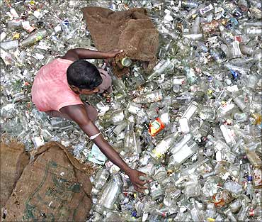 A labourer works at a glass bottle recycling factory.