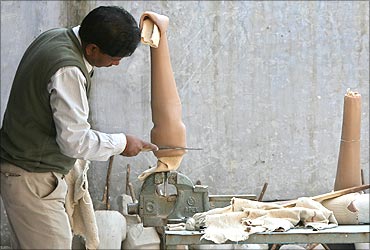 A worker makes an artificial limb at a workshop in New Delhi.