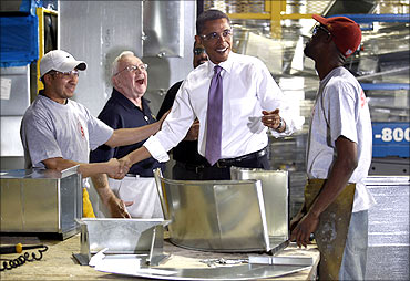 US President Barack Obama with workers during a tour of Stromberg Metal Works.