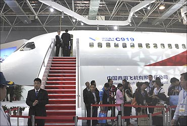 Visitors queue to see a scale model of Chinese-made C919 passenger jet.