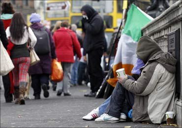 Homeless people beg for money on O'Connell Bridge in central Dublin.