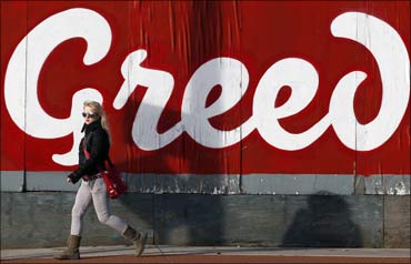 A pedestrian walks past graffitti in Dublin.