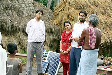 Vinay, Piyush  and Ekta with villagers.