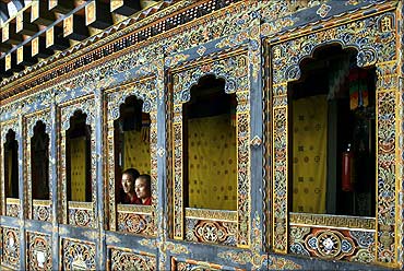 Monks look out of a temple in Tango monastery on the outskirts of Thimphu.