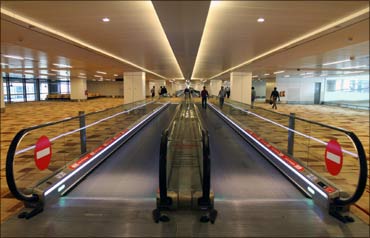 Passengers walk inside the T3 terminal of Indira Gandhi International Airport in Delhi.
