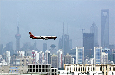 A Shanghai Airlines' passenger airliner flies towards Hongqiao Airport in Shanghai.