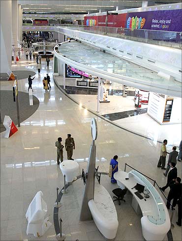 People walk inside Terminal 3 of the New Delhi International Airport.