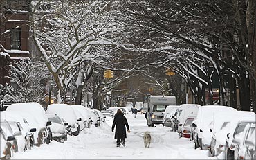 Snow covers a street in Brooklyn, New York.
