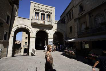 A woman passes the headquarters of Cassa di Risparmio, the largest bank in San Marino.