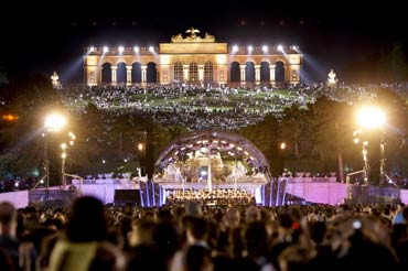 The 'Gloriette' is seen above a stage set up in the park of Schoenbrunn castle as the Vienna Philharmonic Orchestra performs their 'Sommer Night Concert' in Vienna.