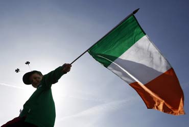 A boy holds a Republic of Ireland flag during a St Patrick's day march in central London.
