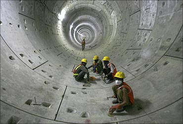 Delhi Metro Rail Corporation employees work inside a tunnel on the phase II stretch.