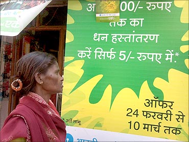 A prospective customer examines the Holi offer to send money home.
