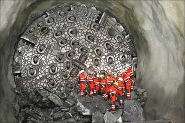 Miners stand in front of the gaby drill.