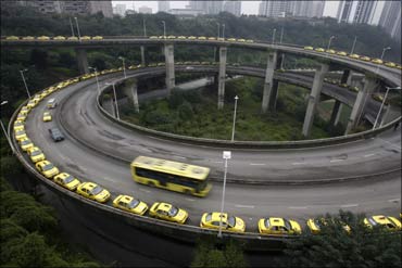 Taxis line up to get their tanks filled on a viaduct in Chongqing municipality.