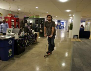 A Google employee rides a company scooter along the corridors at the New York City offices.