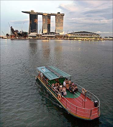 A tourist boat passes Marina Bay Sands casino in Singapore.
