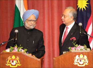 Prime Minister Manmohan Singh (L) listens to his Malaysian counterpart Najib Razak during their joint news conference at the latter's office in Putrajaya outside Kuala Lumpur on October 27, 2010.