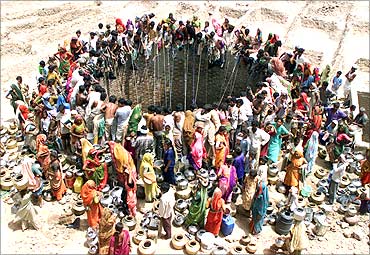 People gather to get water from a huge well in the village of Natwarghad, Gujarat .