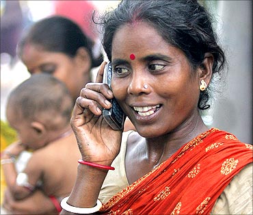 Tulsi Prasad, an Indian slum dweller, uses a mobile phone.