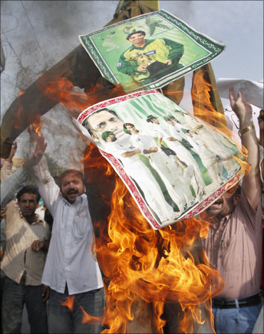 Angry Pakistani cricket fans burning posters of cricketers allegedly involved in spot fixing.
