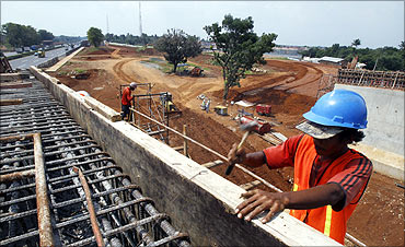 Workers construct a new toll road at Jakarta.