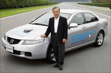 Honda CEO Takanobu Ito poses beside a diesel Accord.