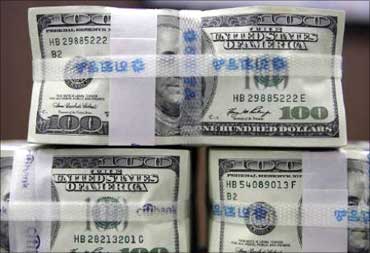 US dollar bills are piled up at a bank.