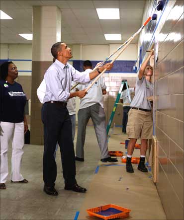 Barack Obama volunteers to paint at National Day of Service and Remembrance event in Washington.