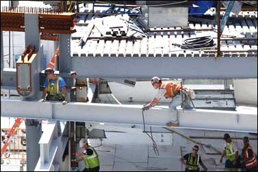 Construction workers work on beams at the World Trade Center construction site in New York.