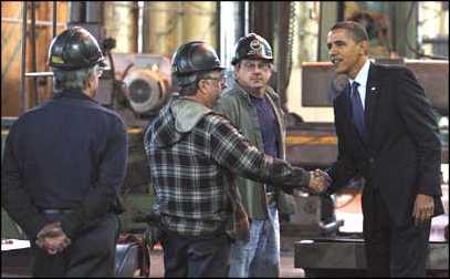 Obama greets workers.