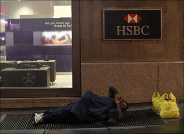 A homeless man sleeps in front of an HSBC branch in New York.