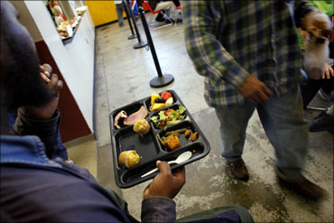 A homeless man holds his plate of food at the Urban Ministry soup kitchen in Charlotte, North Carolina.