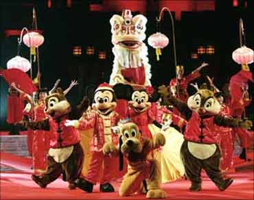 Disney's cartoon characters perform with lion dancers at Hong Kong Disneyland.