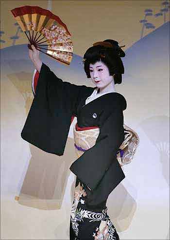 A geisha performs at the Kaburenjo theatre in the Miyagawa district of Kyoto, Japan.