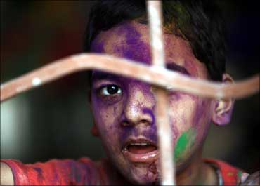 A child suffering from cerebral palsy after celebrating Holi, the festival of colours.