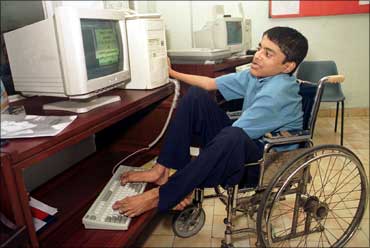 Dipak Ghosh, 15, uses his feet to operate a computer in Kolkata.