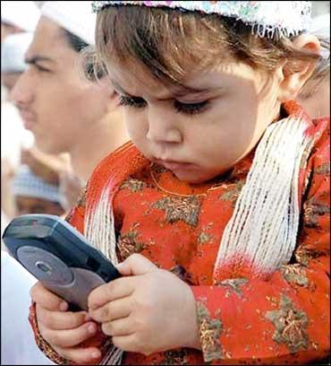 A child plays with a mobile