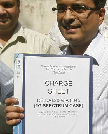 CBI officials carry the 2G spectrum case charge sheet to a court in New Delhi on April 2, 2011.
