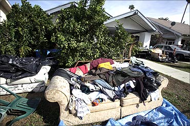 A pile of clothes and a sofa sit outside a foreclosed home in Los Angeles.