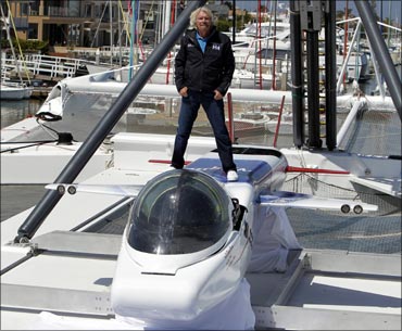 Branson poses on top of the solo-piloted submarine.