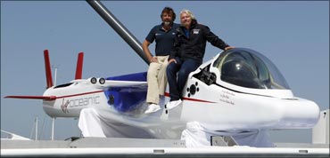 Richard Branson and Chris Welch pose on top of a solo piloted submarine during a photo opportunity at a news conference in Newport Beach, California on April 5, 2011.