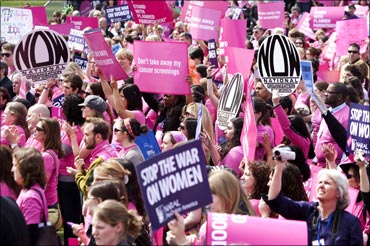 People hold a rally to support preventive healthcare and family planning services in the US.