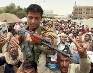Protesters carry an army soldier after he took part in clashes with supporters of Yemeni President.