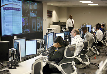 US Dept of Homeland Security analysts work at the National Cybersecurity Communications Center.
