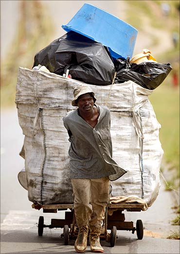 A jobless man pulls a trolley full of recyclable items in Orlando, Soweto in Aouth Africa.
